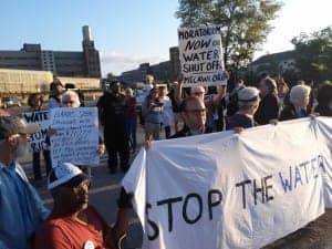 Detroit-water-shut-off-protest-blocks-entrance-Homrich-shut-off-contractor-071014-by-Abayomi-Azikiwe-Pan-African-News-Wire-300x225, 10 arrested blocking trucks sent to shut off water services in Detroit, News & Views 
