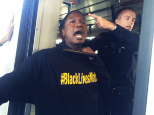 Black-Lives-Matter-West-Oakland-BART-shut-down-both-ways-112814-6-by-Alicia-Garza-300x224, Blackout Collective obstructs BART trains on Black Friday in protest of police killings, Local News & Views 