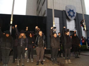 ShutdownOPD-Black-Power-salute-flagpole-climber-121514-by-BaySolidarity-web-300x225, Protesters shut down Oakland Police Department for almost 4.5 hours today, demand end to police aggression against Black people, Local News & Views 