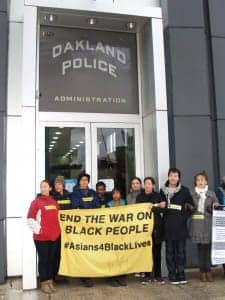ShutdownOPD-chained-Asians4BlackLives-block-OPD-HQ-entrance-121514-by-BaySolidarity-225x300, Protesters shut down Oakland Police Department for almost 4.5 hours today, demand end to police aggression against Black people, Local News & Views 