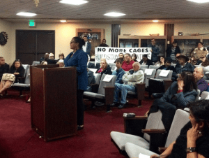 Vonya-Quarles-of-All-of-Us-or-None-testifies-against-new-jail-Adelanto-City-Council-121014-300x226, Immigration policies are criminalizing our communities, News & Views 