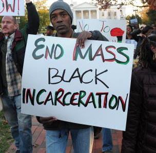 End-Mass-Black-Incarceration-Black-man-holding-sign-at-protest, The value of Black life in America, Part 1, Abolition Now! 