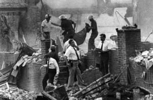 MOVE-bombing-officials-remove-bodies-assess-damage-051385-300x196, The barbaric police bombing of MOVE: May 13th at 30, News & Views 