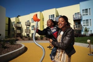 Resident-Jasmine-Hudson-son-at-Ironhorse-grand-opening-Oakland-by-Julio-Cesar-Martinez-300x200, Oakland invites proposals for so-called affordable housing for 12th Street parcel, Local News & Views 