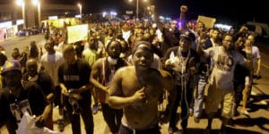 Ferguson-marching-week-of-protests-Mike-Brown-murder-anniversary-081115-by-Charlie-Riedel-AP-300x150, Ferguson police intensify abuse, but no amount of tear gas, hatred and contempt will deter us, News & Views 
