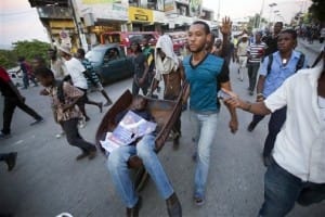 Anti-election-fraud-protesters-cart-man-killed-by-gunshot-Port-au-Prince-Haiti-112015-by-AP-300x200, Defiant Haiti: ‘We won’t let you steal these elections!’, World News & Views 