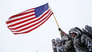 Standing-Rock-vets-march-hold-flag-against-strong-winds-120516-by-AAP-300x169, Veterans at Standing Rock offer long overdue apology to Native elders, News & Views 