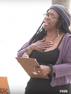 Eloquent-Laure-McElroy-speaks-at-a-rally-227x300, Standing in revolution: Laure McElroy joined the ancestors BlackAugust 31, 2018, Culture Currents 