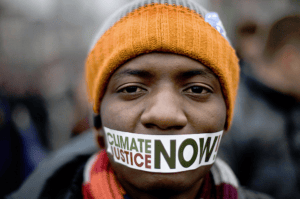 Climate-Justice-Now-on-Black-mans-taped-mouth-by-Wojtek-Radwanski-AFP-300x199, The link between climate justice and police brutality, World News & Views 