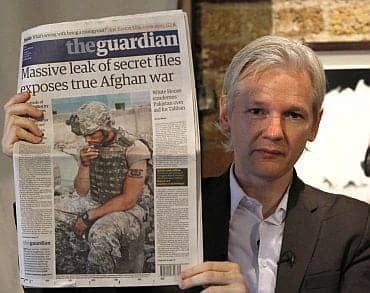 Massive-leak-of-secret-files-exposes-true-Afghan-war-Julian-Assange-holding-Guardian-newspaper, Chelsea Manning defies secret grand jury, Julian Assange scoops Michael Cohen, News & Views 