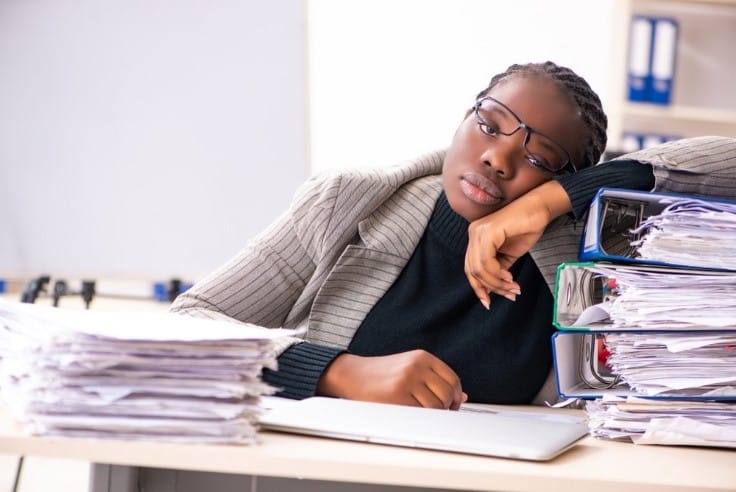 Tired-Black-woman-desk-worker, Stress busters for working parents, Culture Currents 
