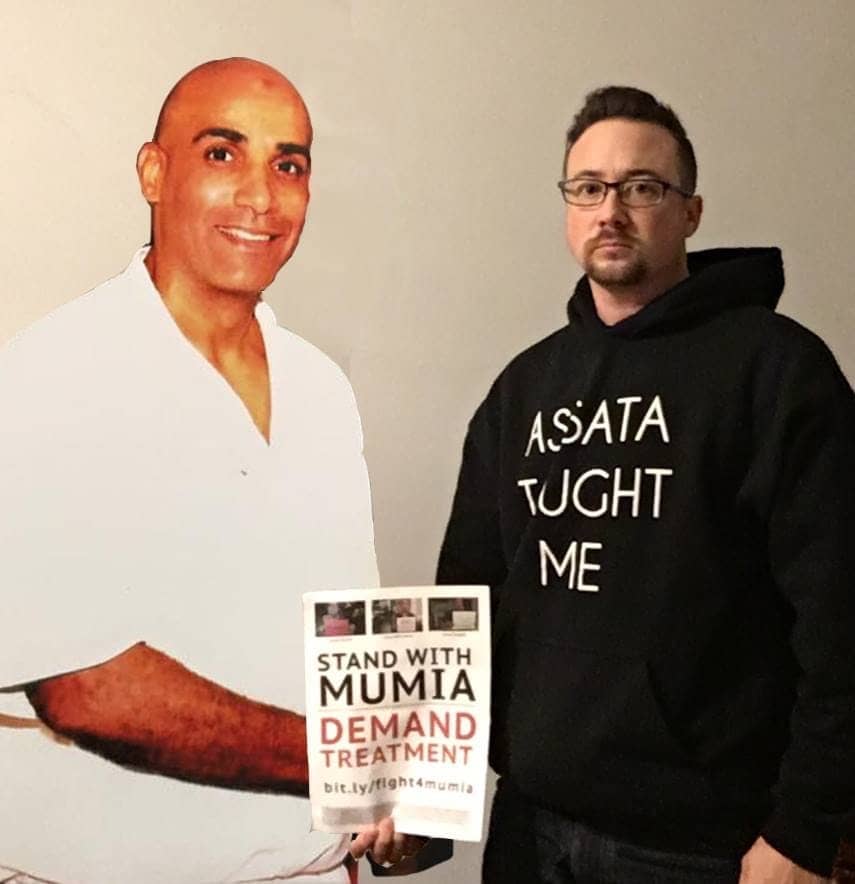 Keith-Malik-Washington-w-Justin-Adkins-wearing-Assata-taught-me-shirt, North Carolina prisoners plan grievance submission to US DOJ on May 7, invite others to join them, Behind Enemy Lines 