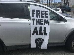 Free-Them-All-sign-on-car, To release more prisoners quickly, grant reprieves, Abolition Now! 
