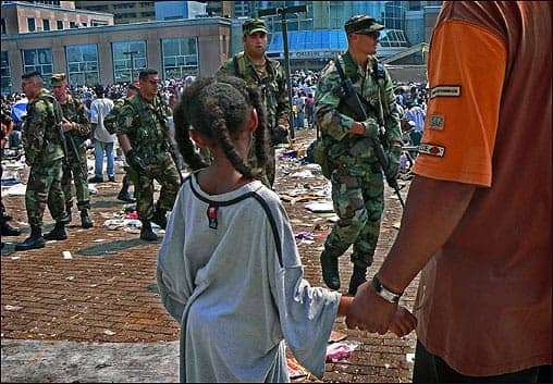 National-Guard-patroling-in-New-Orleans-Superdome-after-Katrina-by-AP, Criminalization will not slow the pandemic, Local News & Views 