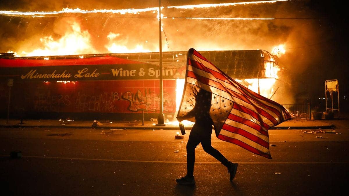 George-Floyd-Protester-carries-flag-as-Minneapolis-police-ordered-to-abandon-posts-as-protests-intensify-052820-by-Julio-Cortez-AP, In defense of Black rebellion, News & Views 