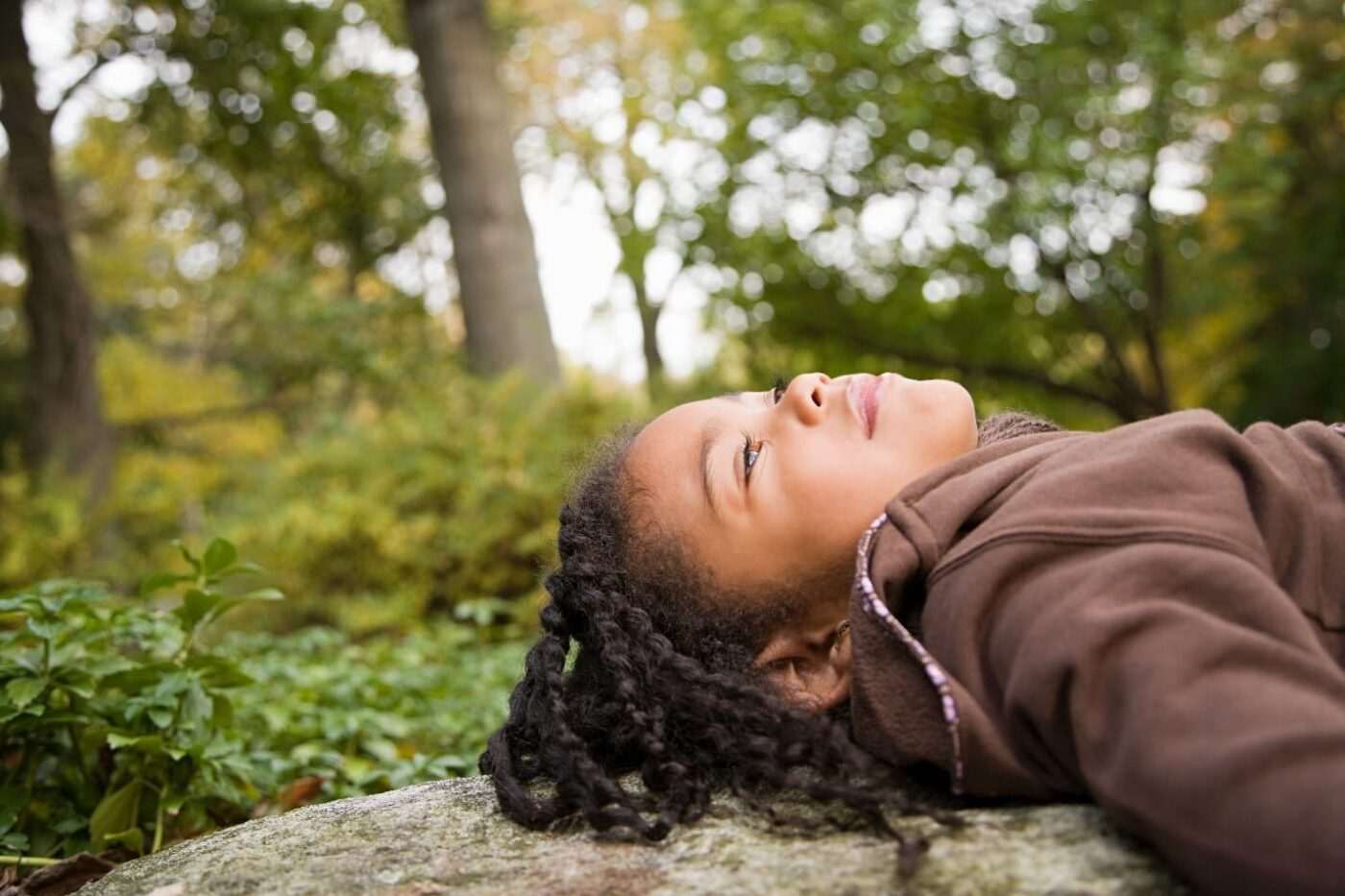 Black-child-lying-on-log-enjoys-nature-1400x933, Coronavirus parenting: Protecting your children during the pandemic, Culture Currents 