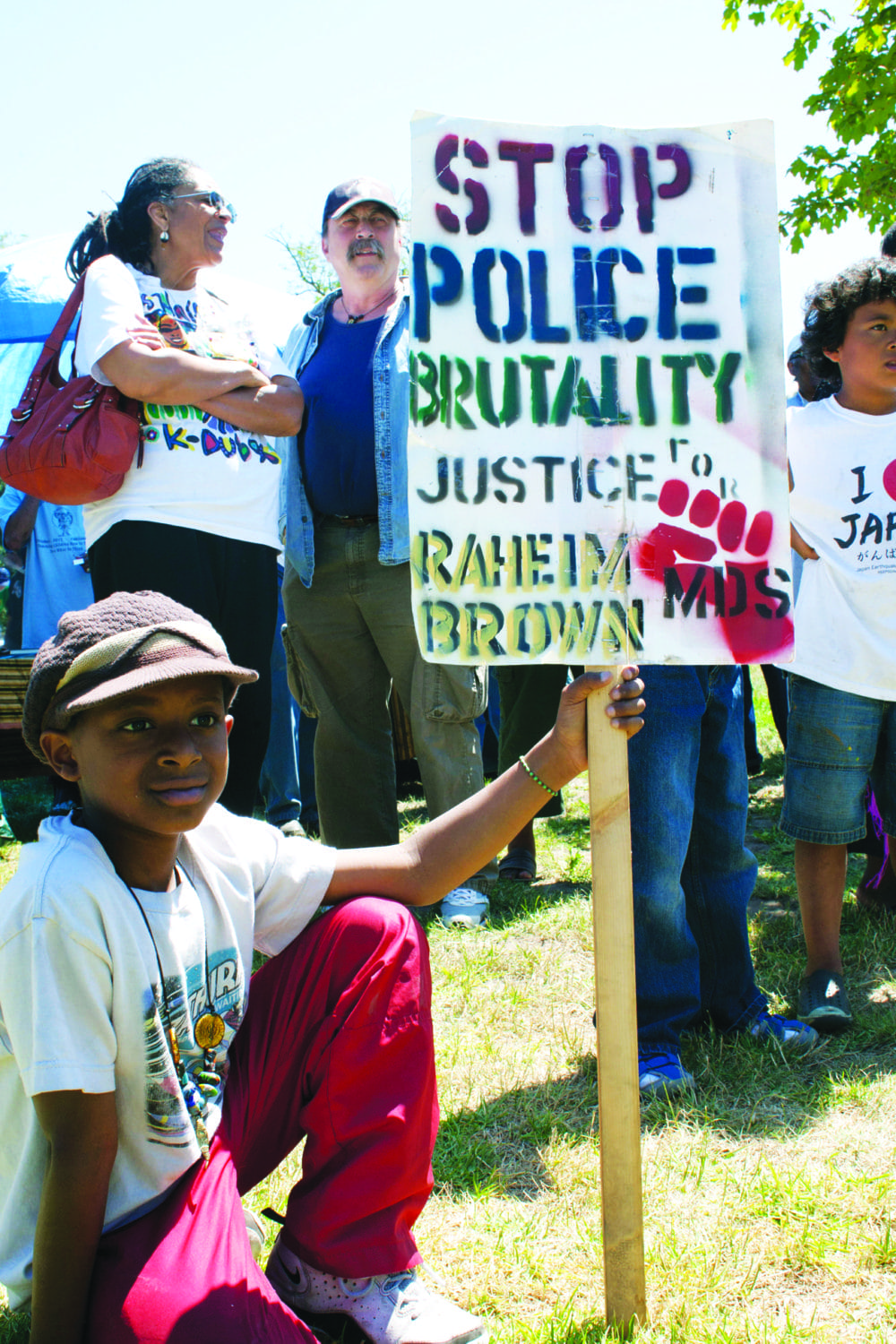Geronimo-Day-Bobby-Hutton-Park-boy-with-Raheim-Brown-sign-071711-by-Malaika, The long arc of resistance to police in Oakland schools, Local News & Views 