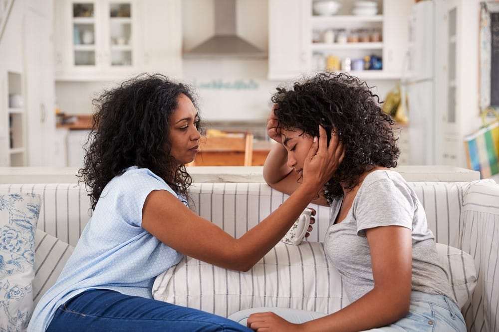 Mother-comforts-teenage-daughter-both-Black, Coronavirus parenting: Protecting your children during the pandemic, Culture Currents 