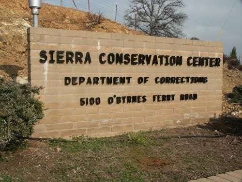 Sierra-Conservation-Center-brick-sign-outside-prison, Coronavirus quarantine means solitary confinement for prisoners, Abolition Now! 