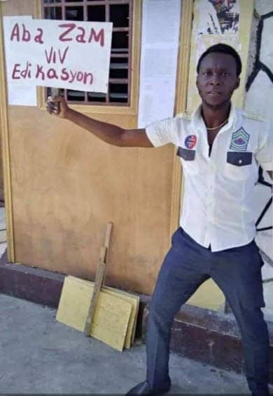 Gregory-Saint-Hilaire-holds-sign-‘Down-with-Weapons-ie-police-G9-type-paramilitaries-Long-Live-Education-Haiti-2020, Stop the massacres in Haiti: End US and UN support for the criminal regime of Jovenel Moise, World News & Views 