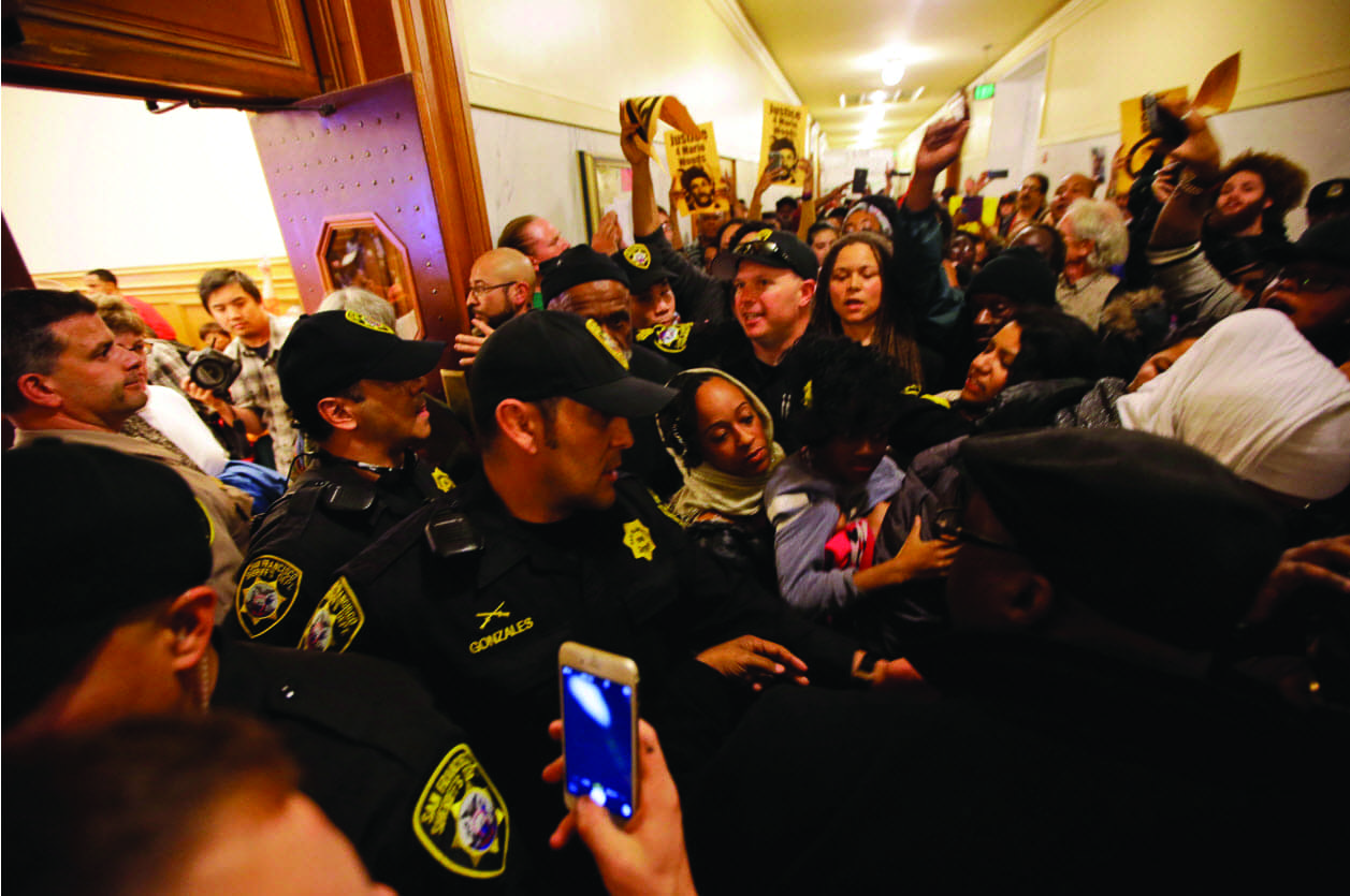 Mario-Woods-protesters-fill-hall-outside-hearing-overflow-rooms-Police-Commission-City-Hall-120915-by-Marcio-Jose-Sanchez-AP-NYT, SF Police Officers Assoc.: ‘We’d sign off on USDOJ reforms tomorrow!’ in exchange for pay raises, Local News & Views 