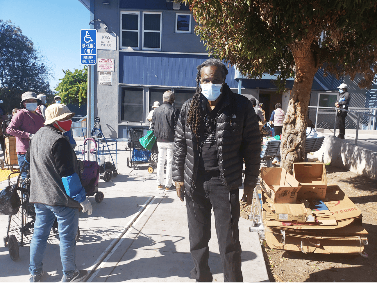 Claude-Carpenter-helps-with-the-line-outside-the-community-center, Struggling for multicultural unity in Bayview Hunters Point, Local News & Views 