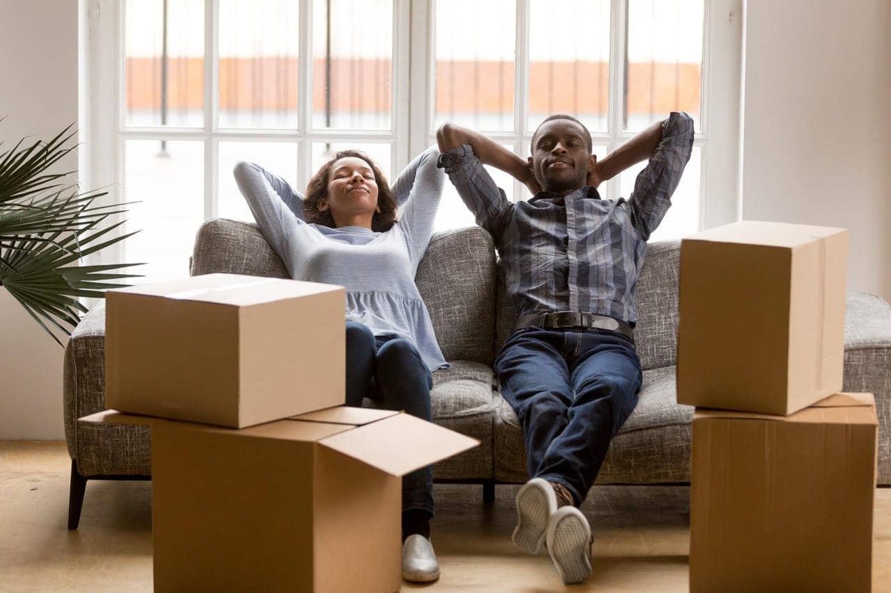 Couple-moving-in-relax-on-couch-by-California-Black-Media, Winners and winners: Big takeaways from new rent law benefitting landlords and tenants, Featured Local News & Views 