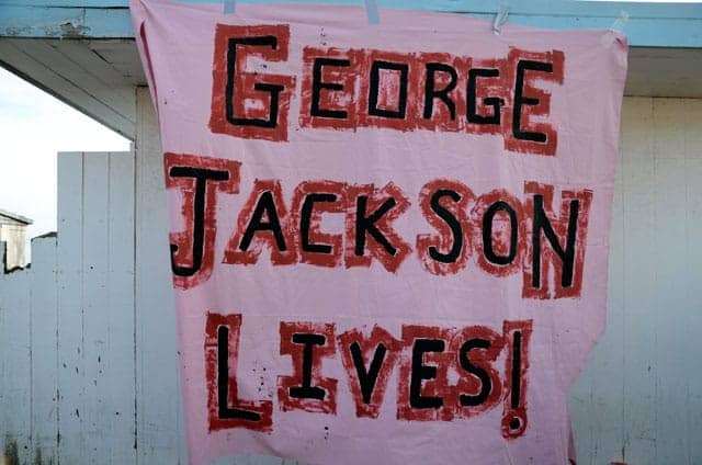 Occupy-San-Quentin-George-Jackson-lives-banner-022012-by-Alex-Darocy-Indybay, George Jackson, 50 years later, Abolition Now! 