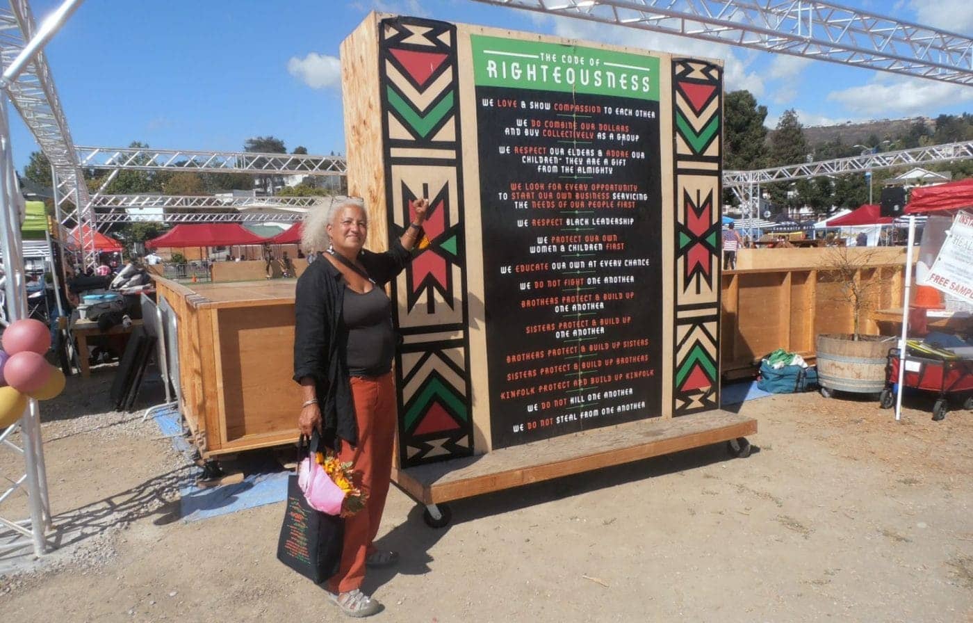 Elana-Serrano-at-The-Code-of-Righteousness-at-the-Akoma-Market-in-East-Oaklands-new-Liberation-Park-by-Jahahara-1400x896, End corporate-military genocide and ecocide!, Culture Currents 