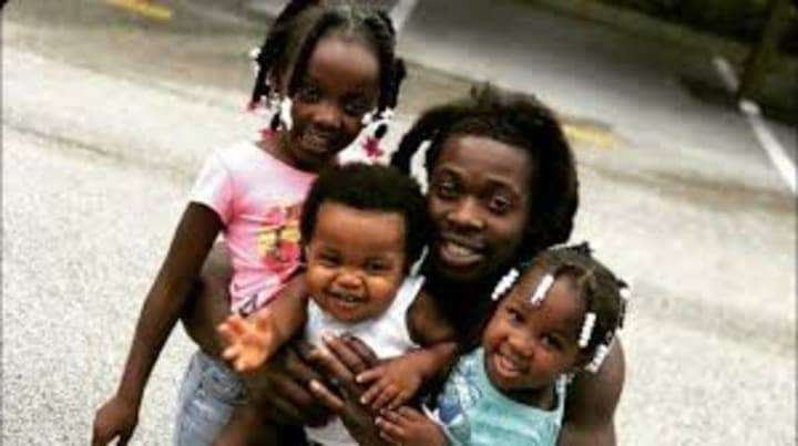 Ozone-aka-Othal-Wallace-hugs-his-babies, Manhunt: Freedom fighter Ozone charged with murdering cop, News & Views 