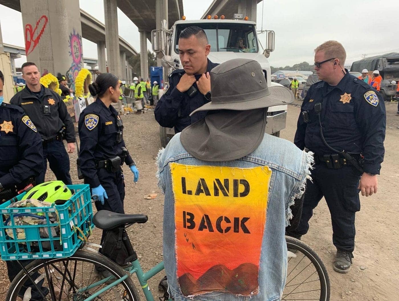 Land-Back-shirt-and-police-and-Wood-Street-in-Oakland-by-Tiny-1400x1055, From Wood Street to where do we go?, Local News & Views News & Views 
