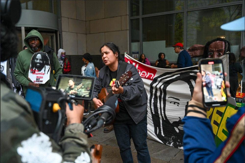 Mumia-rally-Sarah-Torres-with-guitar-outside-courthouse-102622-by-Joe-Piette-flickr, Mumia Abu-Jamal denied a new trial, News & Views World News & Views 