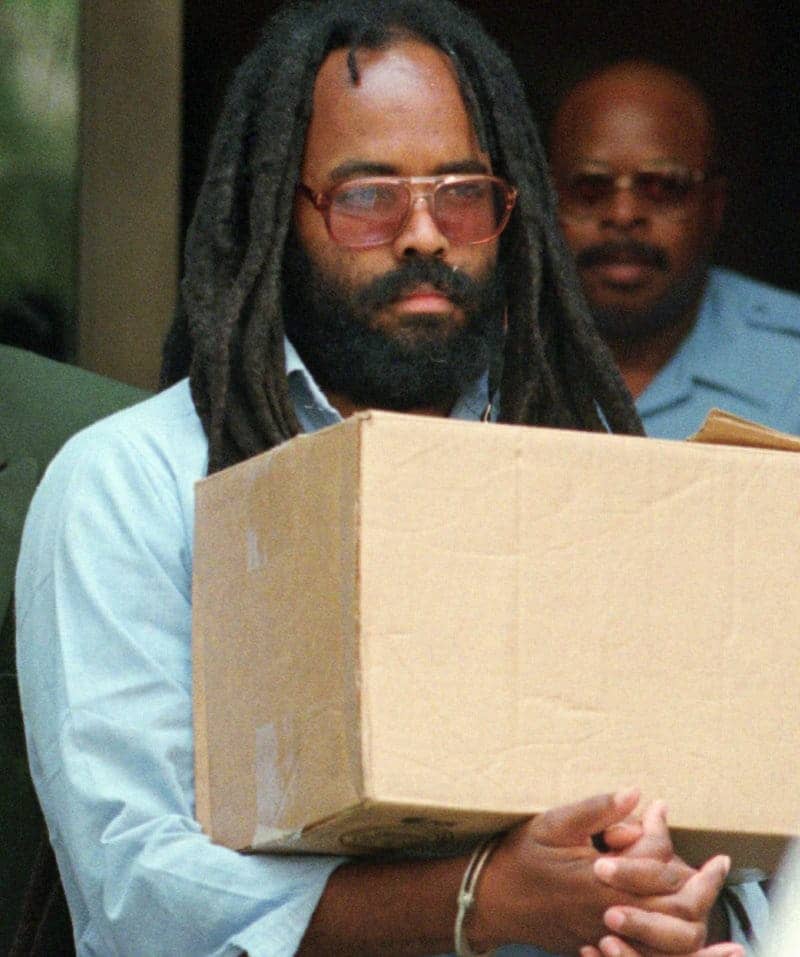 Mumia-handcuffed-carries-box-after-hearing-Philly-City-Hall-0795-by-Chris-Gardner-AP, Judge Clemons cops out: Mumia and the law of lawlessness, Featured News & Views 
