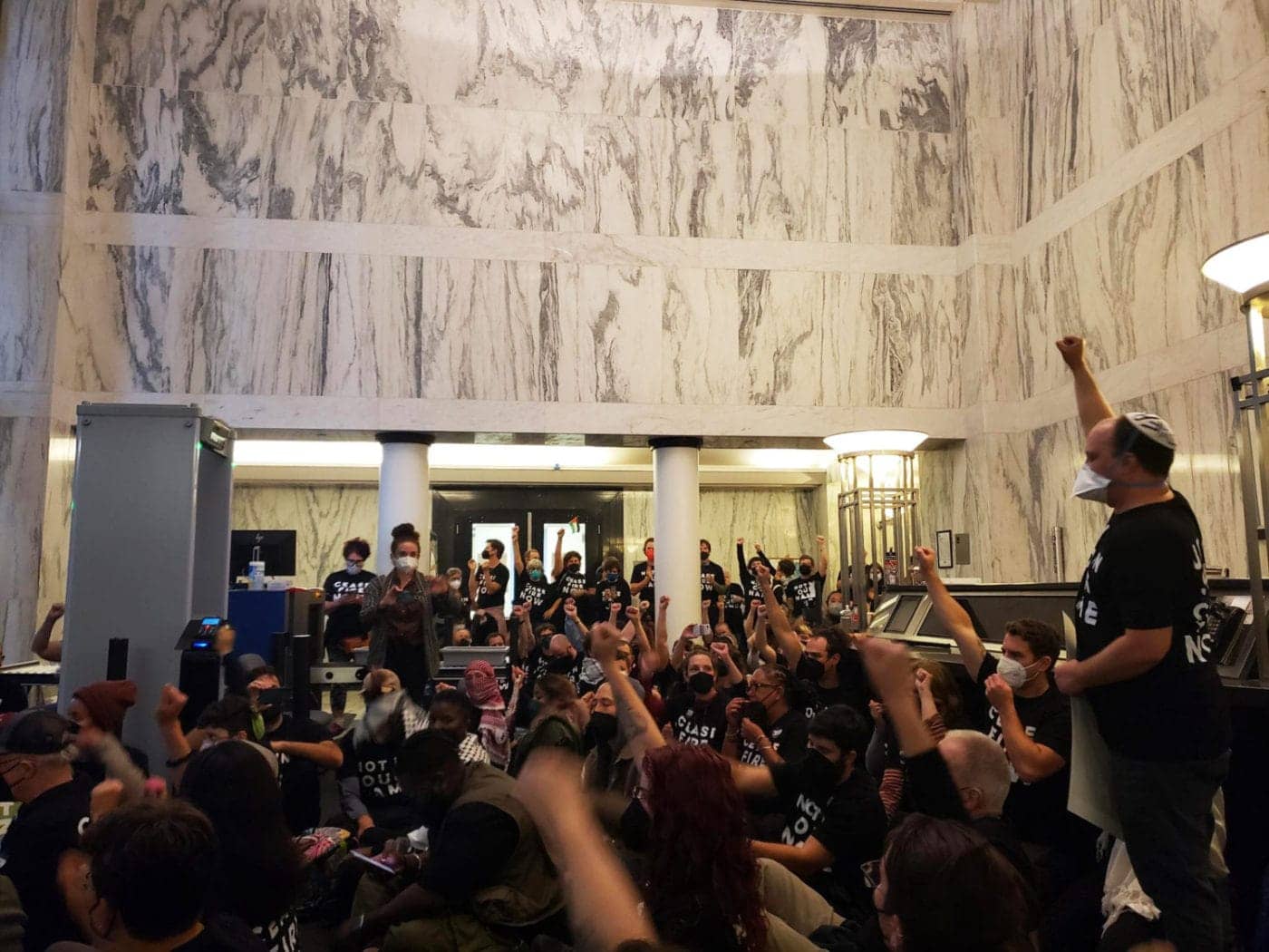 Jewish-Voice-for-Peace-700-occupy-Oakland-Fed-Bldg-fists-up-111323-by-1400x1050, Hundreds of Bay Area Jews arrested in the Oakland Federal Building demanding ceasefire in Gaza, Featured News & Views 