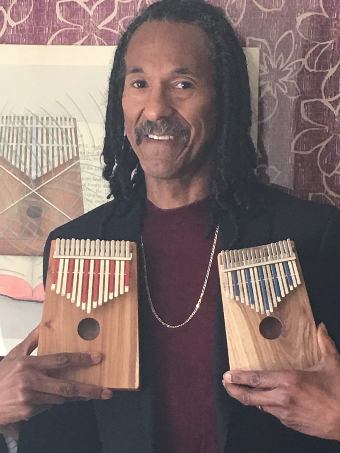 Kalimba-King-Carl-Winters-holds-two-kalimbas, Kalimba King Carl Winters provides the sound track for Black History Month, Culture Currents 