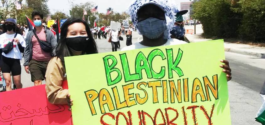 black-palestinian-solidarity-sign-at-rally, Black people who see themselves in Palestinians find that Israel sees the same, Featured Inside/Out Gallery Local News & Views World News & Views 
