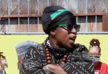 California prison officials label Minister King X a ‘Black Supremacist Extremist’ – King fights back Minister King X standing with his arms crossed. Wearing African male attire, black and white weave pattern.