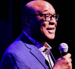 AfroSolo@32 Finale Man in royal blue suit facilitating event.