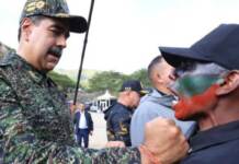Hands off Maduro! Hands off Venezuela! Venezuela Pres. Nicolas Maduro decorates special forces member in Caracas cy Miraflores Palace