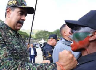 Hands off Maduro! Hands off Venezuela! Venezuela Pres. Nicolas Maduro decorates special forces member in Caracas cy Miraflores Palace