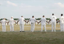 Alabama’s Black Sea: Limestone’s B-Yard Multiple Prisoners dressed in white holding hands stretched in a large circle.