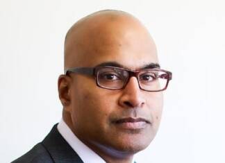 We can’t claim to value justice while starving public defense African American Male wearing down classes and a blue suit and tie with a white shirt.